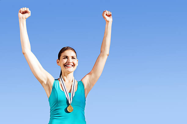 istock Excited Gold Medalist With Hands Raised 520018179