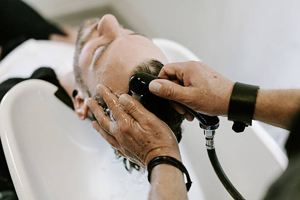istock Overhead View of Barber Washing Hair 520018193