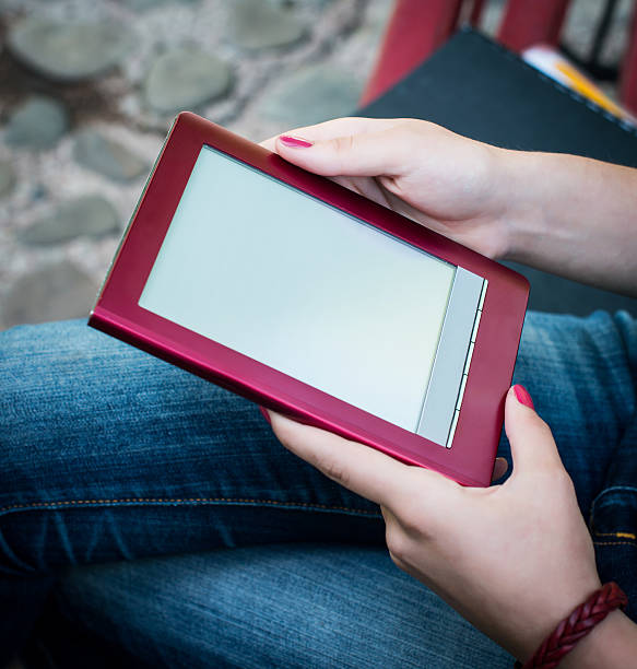 istock Closeup of young girl's hands with tablet PC or e-reader. 520020753