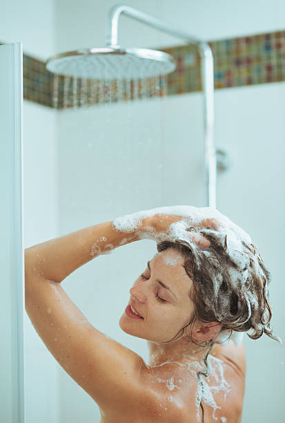 istock young woman washing head with shampoo 520020991