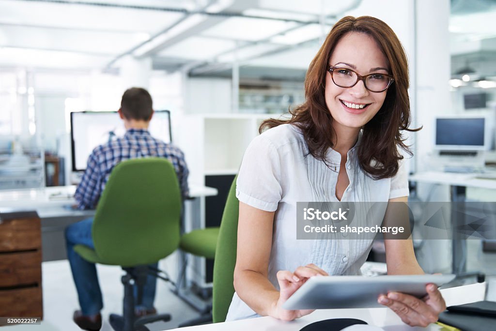 Easy access to important information Portrait of an attractive office worker sitting at her desk using a digital tablet 30-39 Years Stock Photo