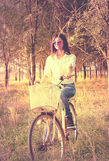 istock Happy young woman with bicycle 520022835