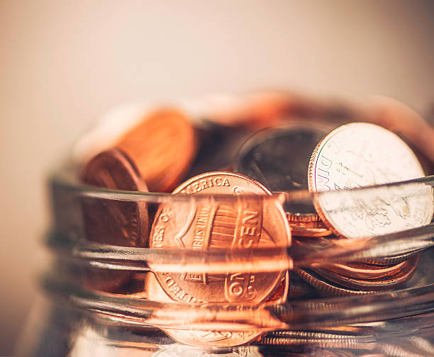 istock Donation jar overflowing with money 520022905