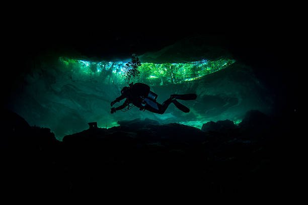 istock Scuba diver exploring the underwater dark caves 520023031