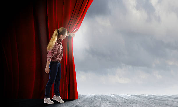 istock Girl opening curtain 520023441