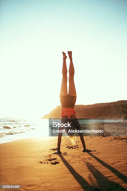 Young Woman Practising Yoga On The Beach Stock Photo - Download Image Now - Adult, Adults Only, Beach