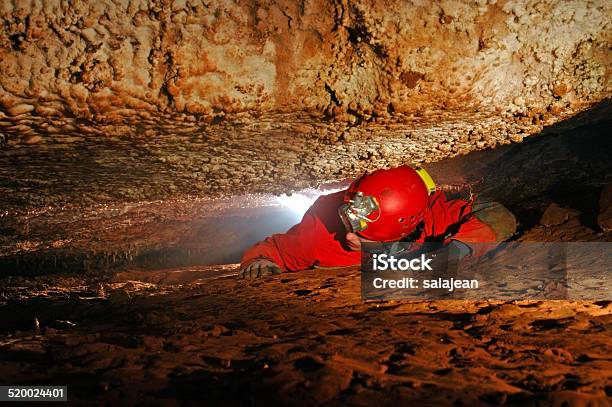 Narrow Cave Passage With A Cave Explorer Stock Photo - Download Image Now - Spelunking, Speleology, Cave