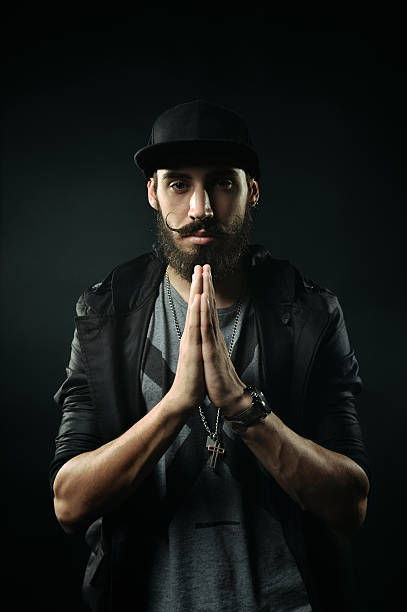 istock The bearded man in a fitted hat praying 520025167