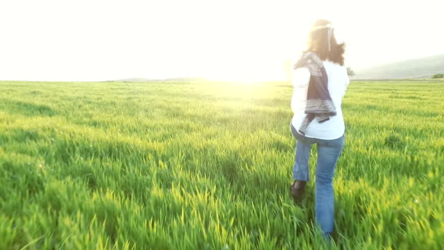 Woman in field enjoying the nature