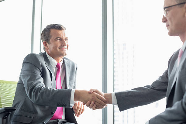 istock Mature businessmen shaking hands in office 520039691