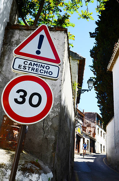 istock cyclist on the narrow road with limit speed 520041271