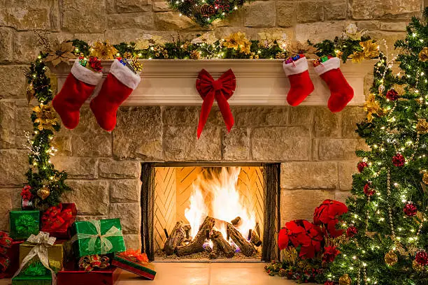 Photo of Christmas fireplace, tree, stockings, fire, hearth, lights, and decorations