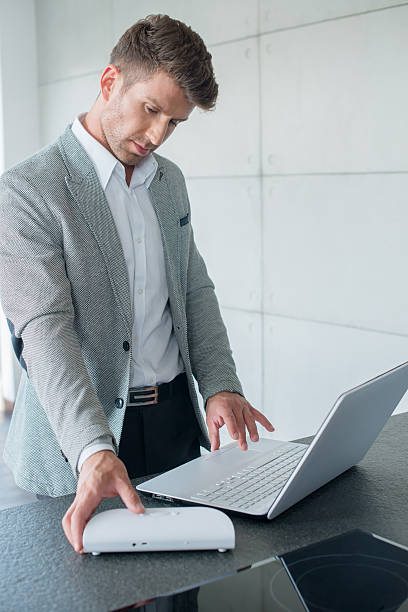 istock Stylish businessman working on a laptop 520042597