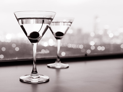 Couple of martini drinks with city background (black and white image).
