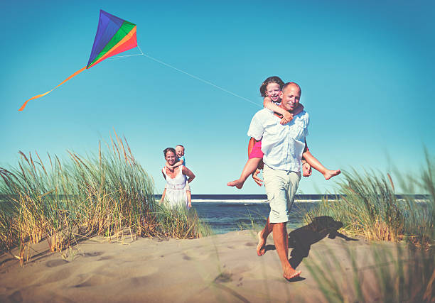 istock Cheerful Family Playing by the Beach Concept 520054522