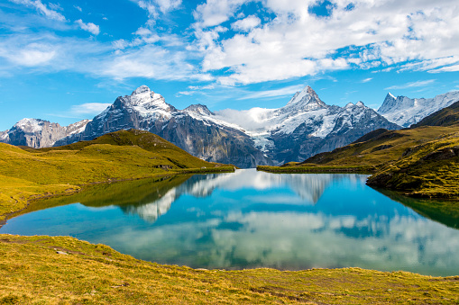 Mirror reflection of Swiss Alps on the still waters of Bachalpsee in Switzerland.