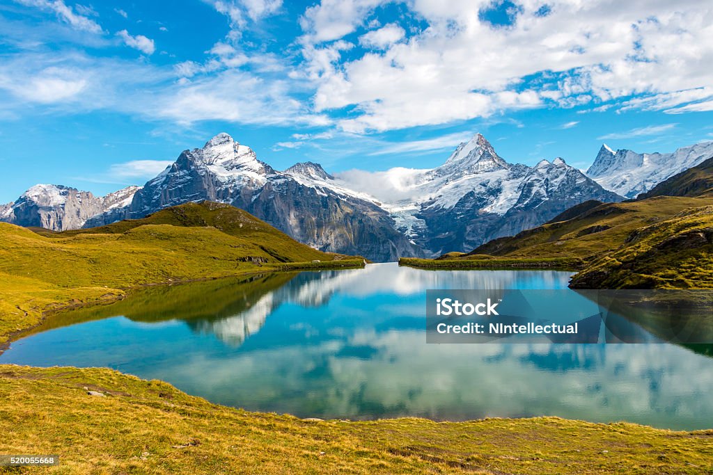 Bernese Oberland Mirror reflection of Swiss Alps on the still waters of Bachalpsee in Switzerland. Monch Stock Photo
