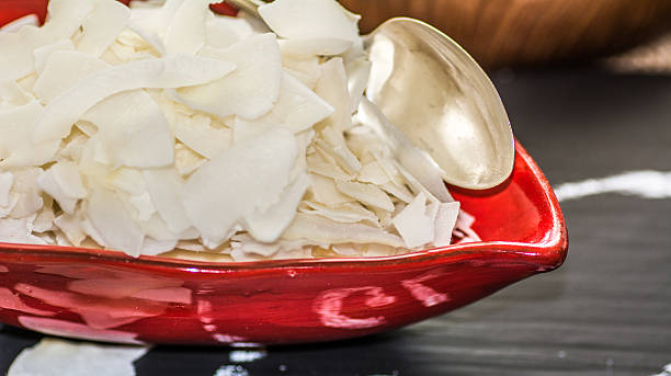 istock Close-up of a bowl of raw coconut chips 520056030