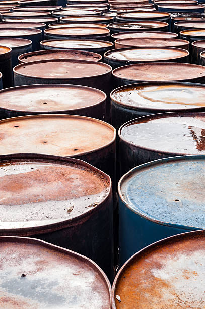 istock Tops of many wet rusted storage drums. 520057442