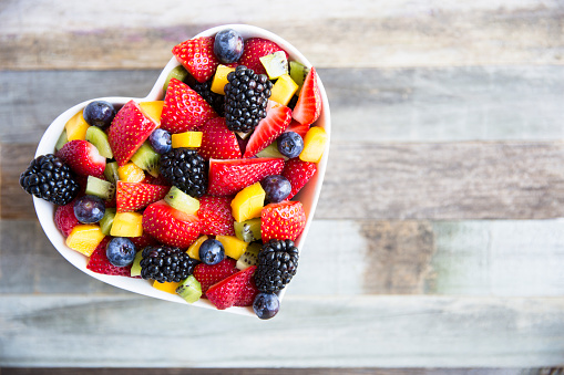 Healthy fresh fruit salad with strawberries, blackberries, mango, blueberries and kiwi.