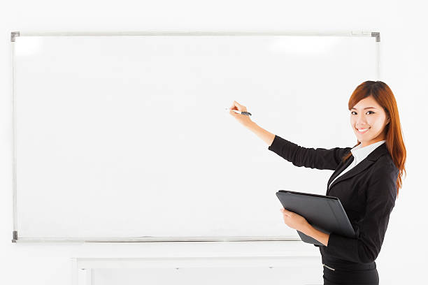 istock asian smiling business woman teaching with a white board 520071349
