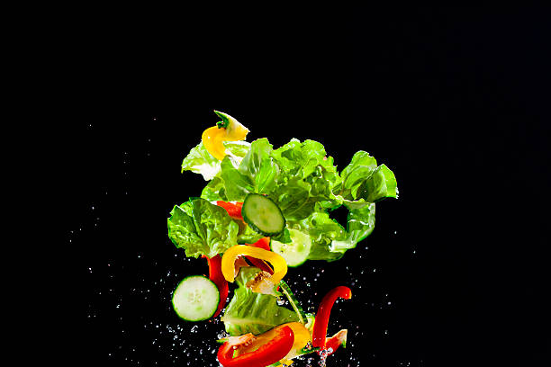 istock Fresh vegetables and water thrown in the air 520074211