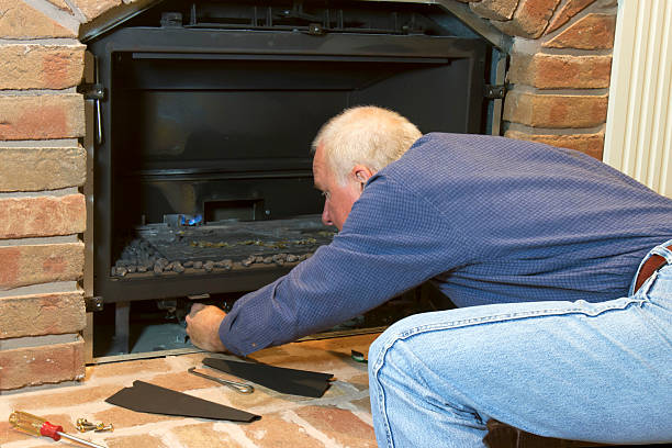 Seasonal Maintenance on Gas Fireplace stock photo