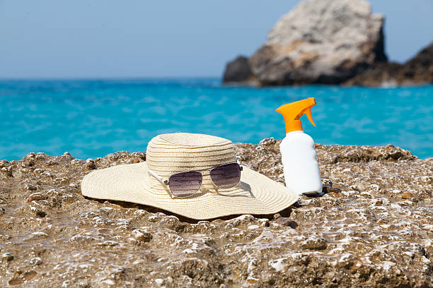 istock Hat and sun cream on the beach 520075125