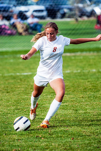 istock Attractive Female Soccer Player Approaches Ball 520075237