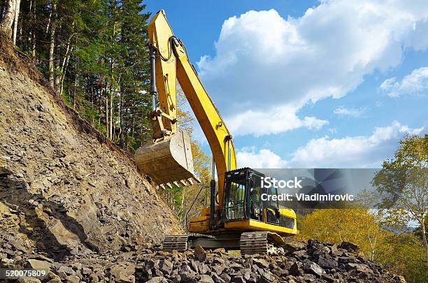 Yellow Excavator Digging Stock Photo - Download Image Now - Forest, Digging, Tractor