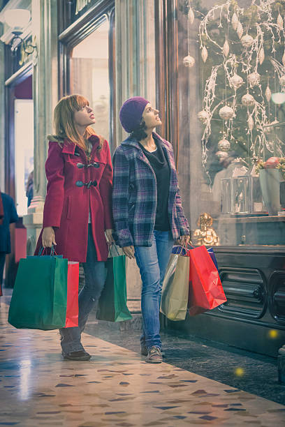 Young women looking for christmas present around old town centre