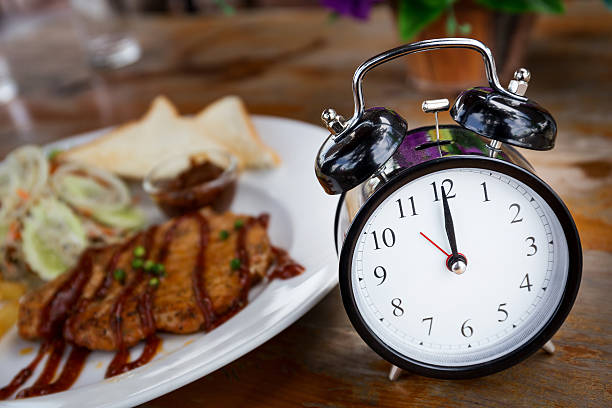 Clock auf Holztisch mit steak auf den Hintergrund – Foto