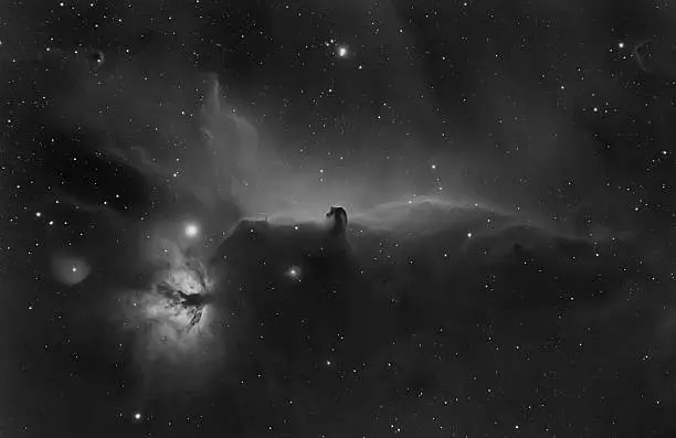 Flame (NGC 2024) and Horsehead (Barnard 33) nebula and beautifull emission courtains behind it (IC434) in Orion constellation. Picture taken with professional CCD camera and refractor-telescope (520mm, f/6,5) ha-alpha wavelength, total exposure time: 210 minutes.
