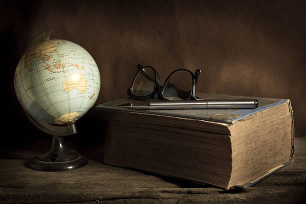 istock Still life globe with book,pen and eyeglasses. 520077447