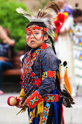 Banff, Canada - July 3, 2014: A young native Blackfoot indian dancer gets ready for his performance during the Banff Summer Arts festival. The Banff Summer Arts Festival is the longest running arts festival in Canada held every summer since 1933.