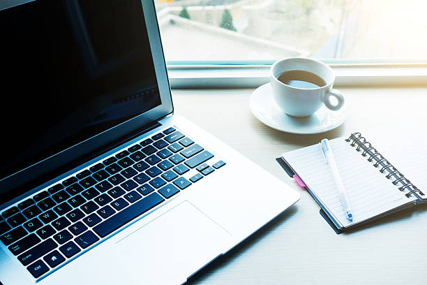 istock Laptop with coffee and notebook on desk 520086184
