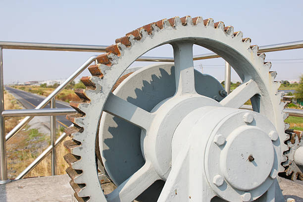 istock rusty gear of floodgate with road background 520086226
