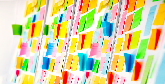 Wall covered with colorful sticky notes.