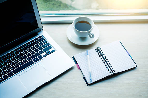 istock Laptop with coffee and notebook on desk 520087826