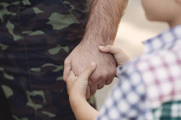 Little boy and soldier in a military uniform stock photo