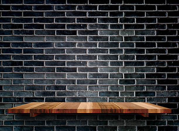istock Empty wooden shelfs on black brick wall, Mock up 520091890