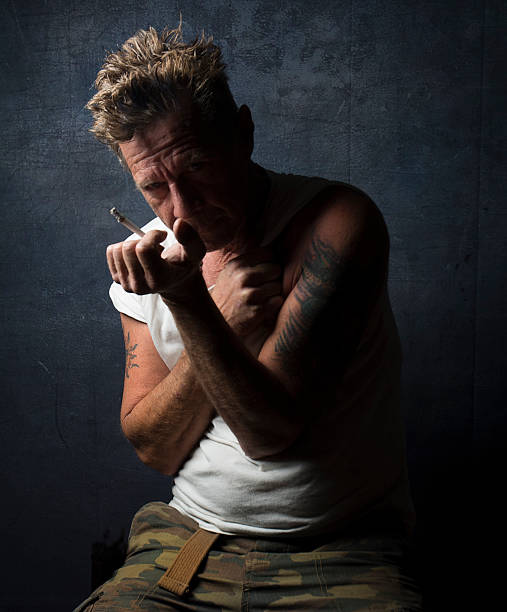 istock Depression Male Smoking Cigarette In Shadow 520093266