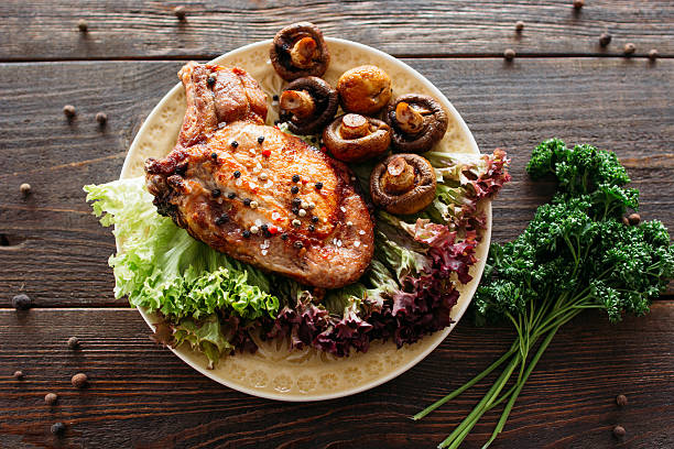 istock Grilled pork dish with lettuce and mushrooms 520096188