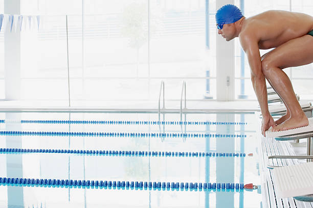 Swimmer on starting blocks Swimmer on starting blocks start block stock pictures, royalty-free photos & images