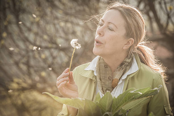 istock Mature woman with dandelion 520097582