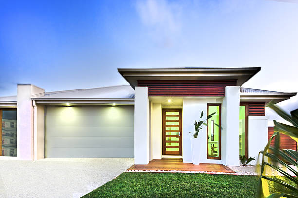 istock Luxurious mansion and a lawn against blue sky background 520098338