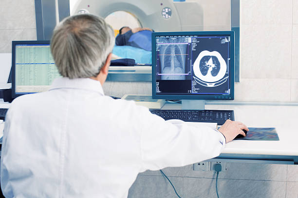istock Doctor operating CT scanner in hospital 520098788