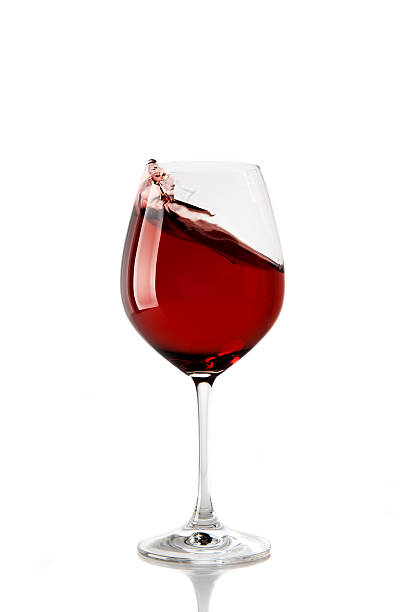 istock Splash of red wine in glass 520112935