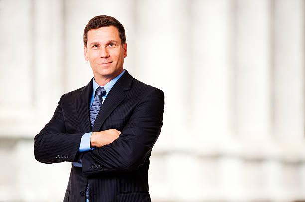 Successful business man looking at the camera smiling outdoors