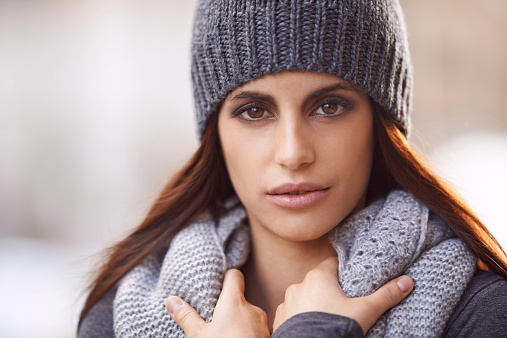 Cropped portrait of a beautiful young woman wearing stylish winter clothing